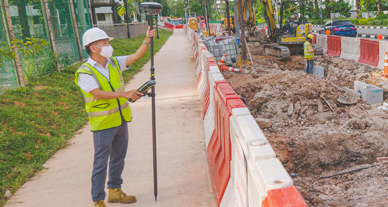 A surveyor on construction site measuring poin cloud with Leica GS18I